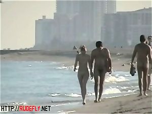peeping at a molten nudist duo on the beach